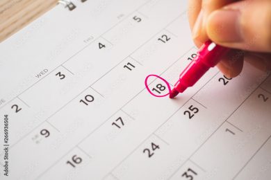 Female Hand with pen mark on calendar date